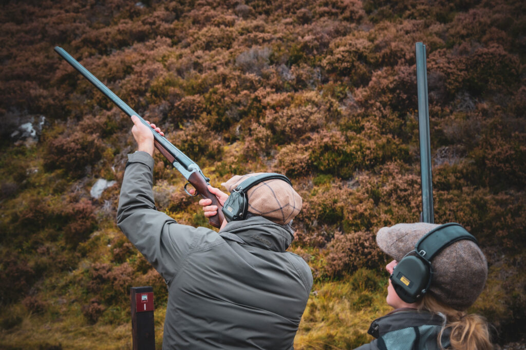 A guest takes aim at a low-ground shoot (Ben Alder Estate).