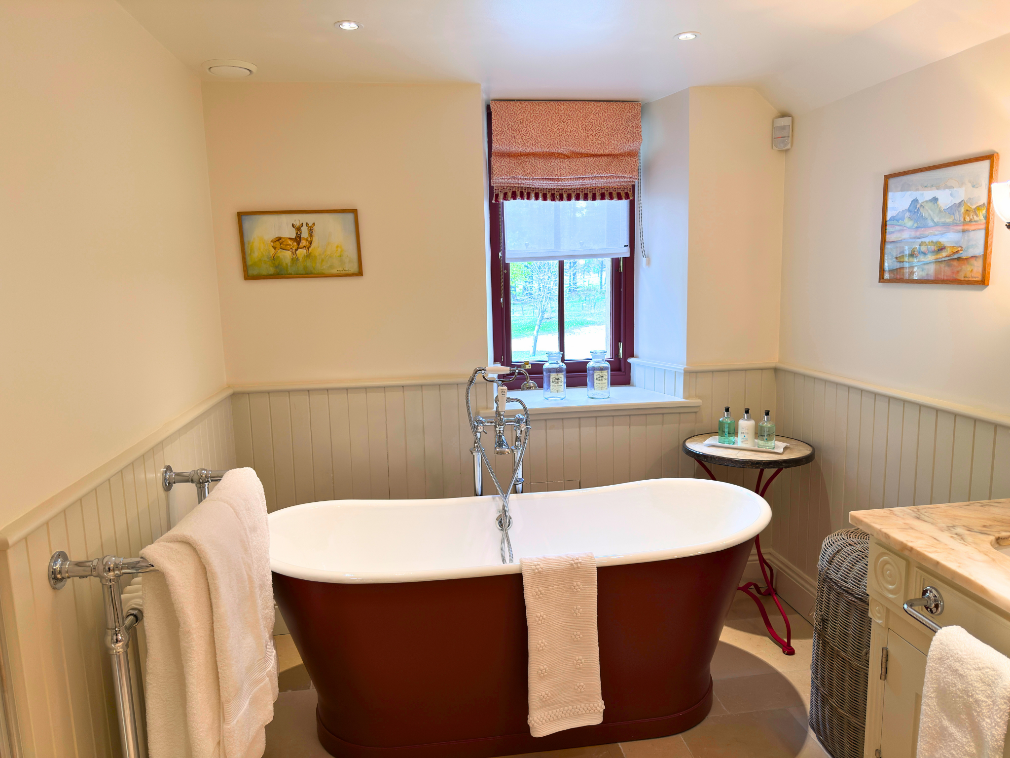 A luxurious bath with a view out of the ensuite bathroom in Dalnaspidal lodge (Ben Alder Estate).