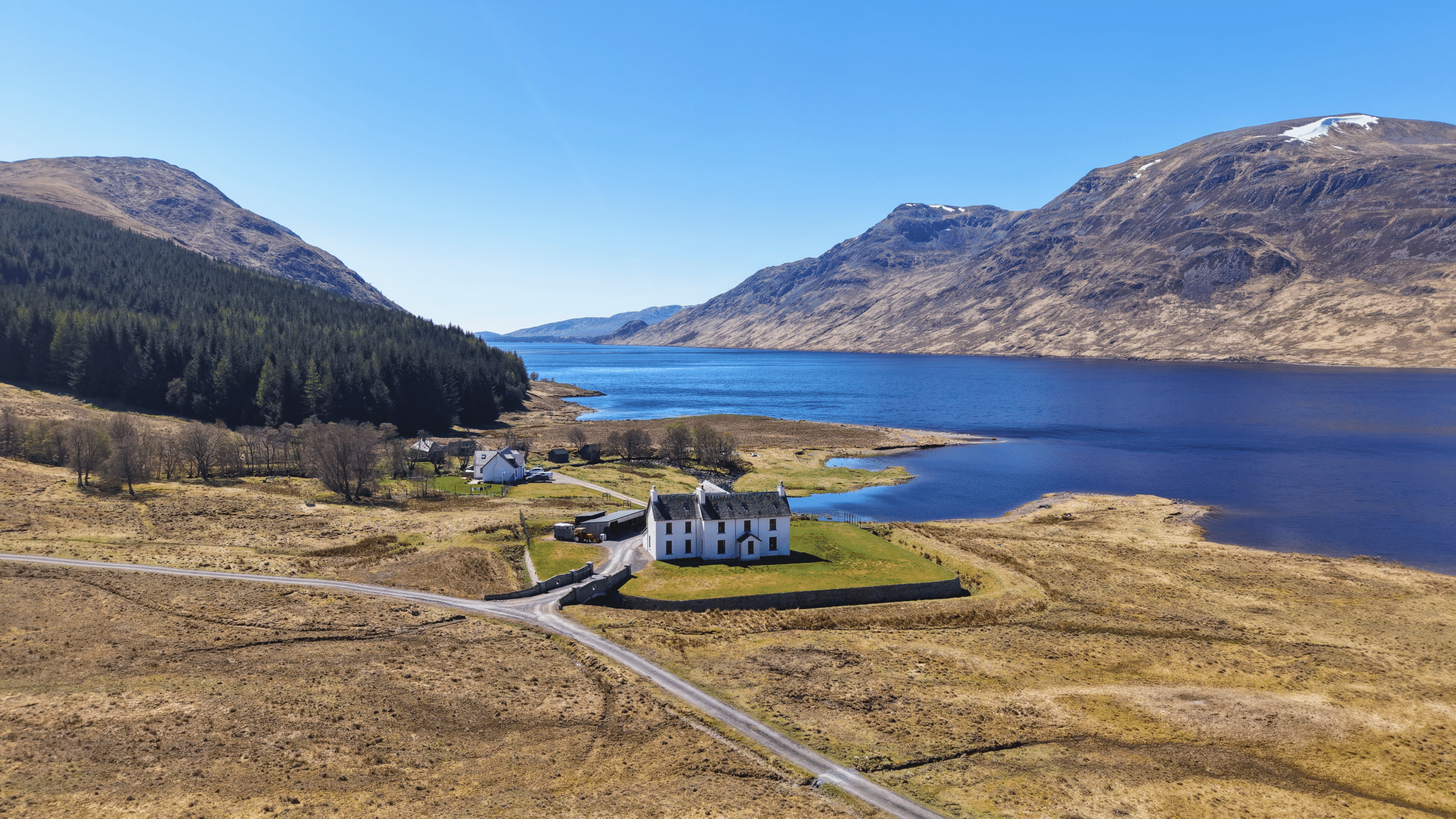 A wide landscape shot of Corrievarkie Lodge (Ben Alder Estate) in summer.