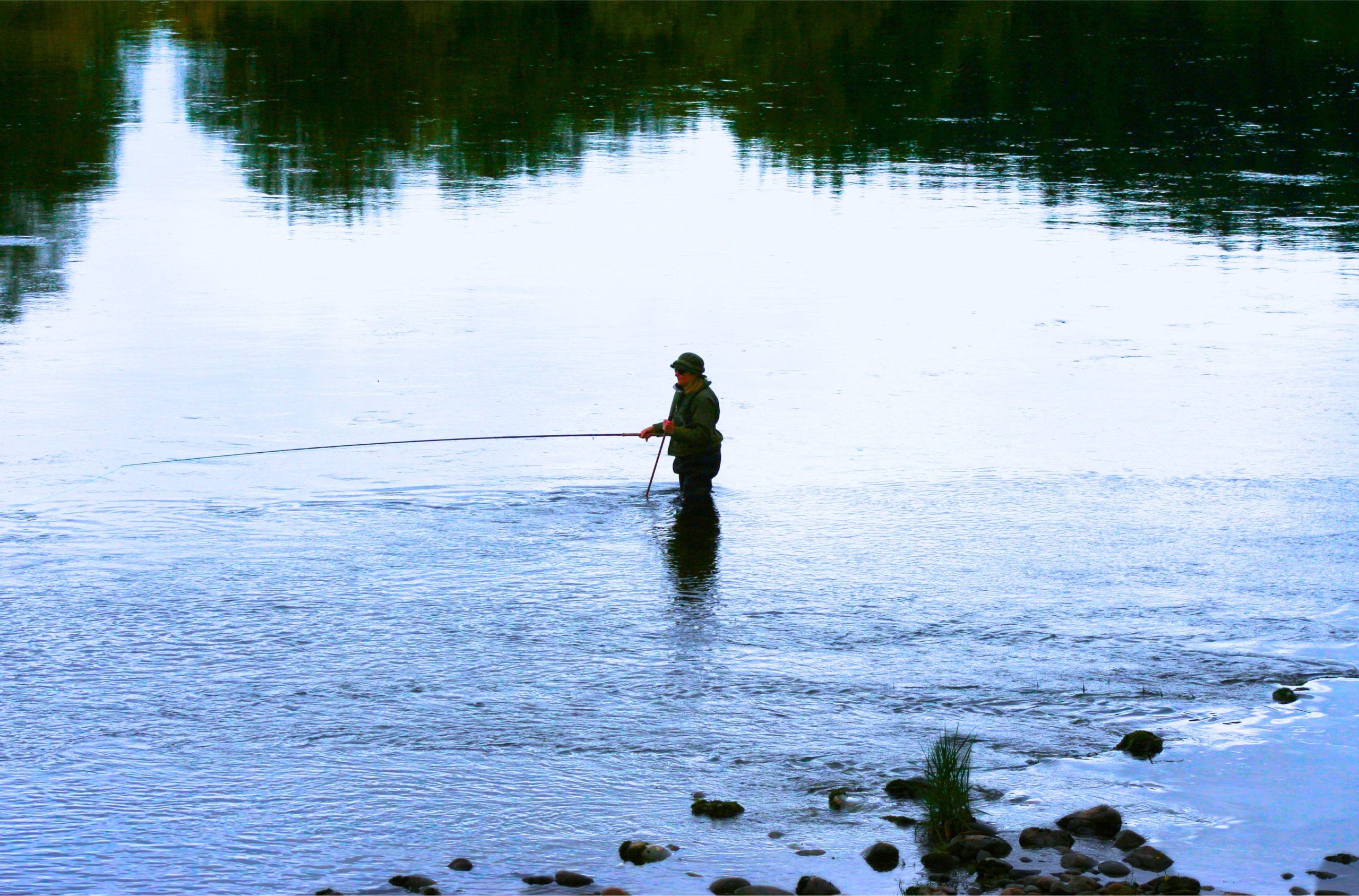 A guest fishes for wild salmon on the River Spey (Ben Alder Estate).